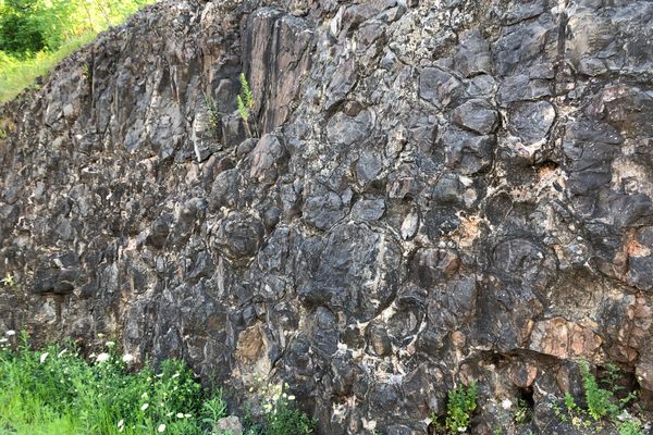 Lava pillows visible in the rock cut.